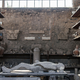 A body cast and amphorae in a storage area in Pompeii.